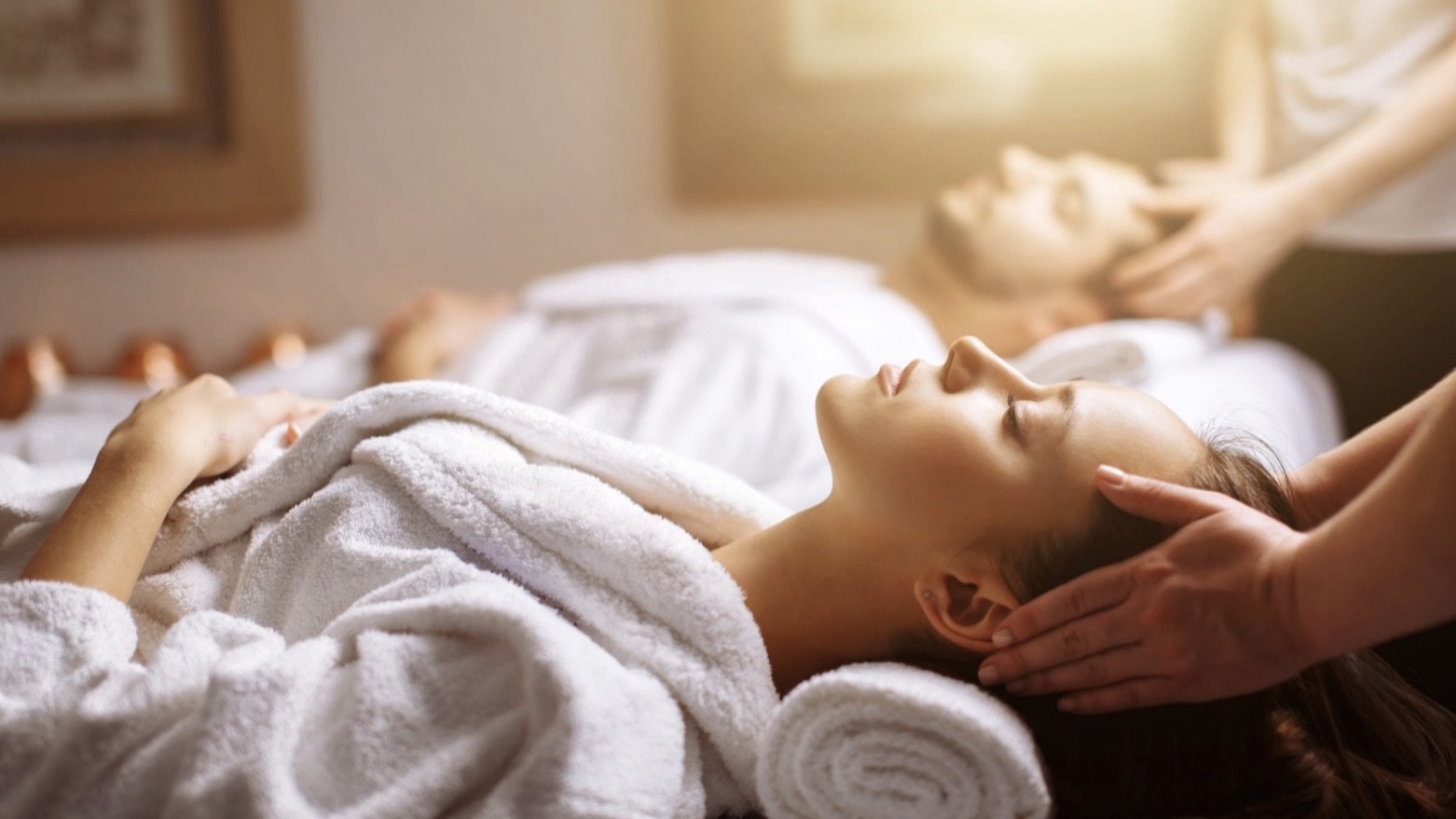 Two guests receiving a couples massage